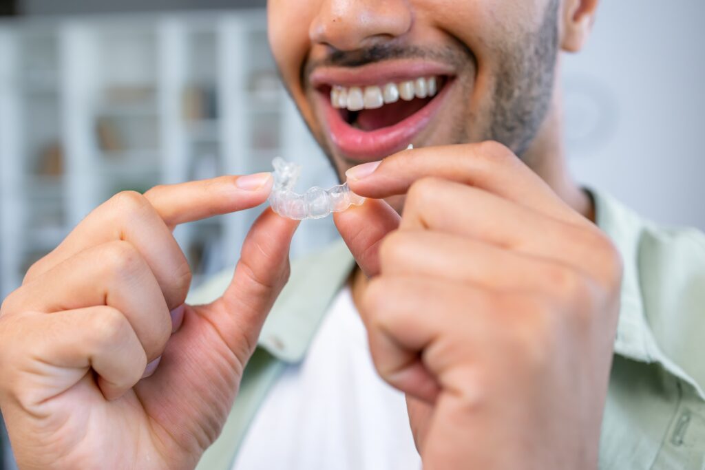 Man putting in clear aligners.